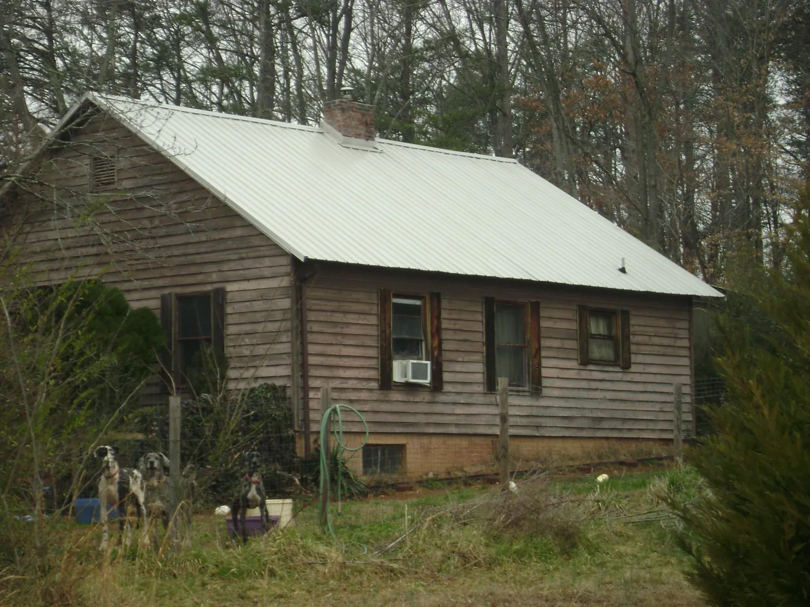 White metal roof on an old wood sided farmhouse, from a Asphalt Shingle Roof Repair job in Votaw